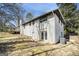 Rear exterior view showing the white-bricked home, back yard, deck, and walkout basement at 5595 Richland Dr, Douglasville, GA 30135