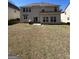 Backyard view featuring a grassy area with the house in the background at 5625 Jamerson Dr, South Fulton, GA 30349