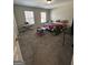 Bedroom with carpet flooring, featuring a bed, desk, and a bright window with blinds at 5625 Jamerson Dr, South Fulton, GA 30349