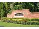 A brick neighborhood entrance sign for Stonewall Manor with manicured landscaping creates an inviting entry to the community at 5625 Jamerson Dr, South Fulton, GA 30349