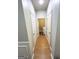 Hallway showing access to the laundry room, hardwood floors, and neutral paint at 5625 Jamerson Dr, South Fulton, GA 30349