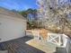 Back deck offers outdoor living space with views of the wooded yard and flowering trees at 10067 Freeman Ct, Jonesboro, GA 30236