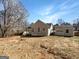 Spacious backyard featuring a back deck with stairs, a fence, and a detached garage at 10067 Freeman Ct, Jonesboro, GA 30236