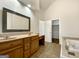 Bathroom with double sink vanity, separate tub, and walk-in closet access at 10067 Freeman Ct, Jonesboro, GA 30236