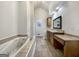 Bright bathroom featuring a jacuzzi tub, double sinks, vanity and tiled floors at 10067 Freeman Ct, Jonesboro, GA 30236
