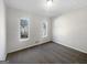 Bright bedroom with two windows and neutral carpeting at 10067 Freeman Ct, Jonesboro, GA 30236