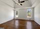 Bedroom featuring hardwood floors, large windows providing lots of light, and a trey ceiling at 10067 Freeman Ct, Jonesboro, GA 30236