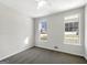 Bedroom featuring a ceiling fan, two windows, and neutral carpeting at 10067 Freeman Ct, Jonesboro, GA 30236