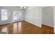 Bright dining room featuring hardwood floors, a chandelier, and natural light from the adjacent outdoor deck at 10067 Freeman Ct, Jonesboro, GA 30236