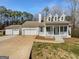 Charming home featuring an attached garage, a detached garage, and a welcoming front porch at 10067 Freeman Ct, Jonesboro, GA 30236
