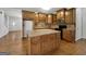 Updated kitchen with stone countertops, stainless appliances, hardwood floors, an island, and wood cabinets at 10067 Freeman Ct, Jonesboro, GA 30236