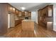 Traditional kitchen features an island, wooden cabinets, hardwood floors, and a desk at 10067 Freeman Ct, Jonesboro, GA 30236