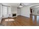 Open living room featuring hardwood floors, a fireplace with built-in shelves and an open archway at 10067 Freeman Ct, Jonesboro, GA 30236