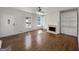 Bright living room featuring hardwood floors, a fireplace with built-in shelves, and large windows at 10067 Freeman Ct, Jonesboro, GA 30236