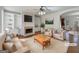 Bright living room featuring hardwood floors, a fireplace, and built-in shelves; virtually staged at 10067 Freeman Ct, Jonesboro, GA 30236