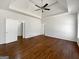 Spacious main bedroom featuring hardwood floors, a ceiling fan, a trey ceiling, and double doors at 10067 Freeman Ct, Jonesboro, GA 30236