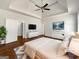 Spacious main bedroom features hardwood floors, a ceiling fan, and ample closet space; virtually staged at 10067 Freeman Ct, Jonesboro, GA 30236