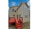 Back exterior featuring siding and a red wood deck with stairs to the backyard at 483 Fairlane Nw Cir, Atlanta, GA 30331