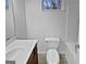 Clean bathroom with a vanity sink, neutral flooring, and a standard white toilet at 483 Fairlane Nw Cir, Atlanta, GA 30331