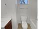 Bright bathroom featuring a toilet, sink with cabinet, and combination tub and shower at 483 Fairlane Nw Cir, Atlanta, GA 30331