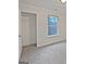 A bright bedroom with neutral carpet and a window showcasing a lush, green view at 483 Fairlane Nw Cir, Atlanta, GA 30331
