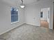 Bright bedroom with tiled floor, open door, natural light from window, and chandelier at 483 Fairlane Nw Cir, Atlanta, GA 30331