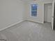 Cozy bedroom with neutral walls, carpeted floor, window, and a closet at 483 Fairlane Nw Cir, Atlanta, GA 30331