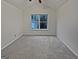 A well-lit bedroom with neutral carpet and a large window showcasing a peaceful view at 483 Fairlane Nw Cir, Atlanta, GA 30331