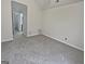 Bedroom with a carpet flooring, grey walls, and a doorway leading to the bathroom at 483 Fairlane Nw Cir, Atlanta, GA 30331