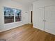 Bedroom with wood floors, window, entry door, and closet at 483 Fairlane Nw Cir, Atlanta, GA 30331
