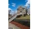 Charming two-story home featuring a white staircase, black shutters, and manicured front yard at 483 Fairlane Nw Cir, Atlanta, GA 30331