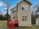Rear view of the home featuring a red deck and ample windows for natural light at 483 Fairlane Nw Cir, Atlanta, GA 30331