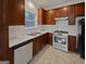 Traditional kitchen featuring dark wood cabinets, stainless steel appliances and white countertops at 483 Fairlane Nw Cir, Atlanta, GA 30331