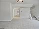 Neutral walls, plush carpet, and stairs leading to the next level create a cozy living space at 483 Fairlane Nw Cir, Atlanta, GA 30331