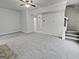 Bright, carpeted living room featuring open layout, ceiling fan, and staircase at 483 Fairlane Nw Cir, Atlanta, GA 30331