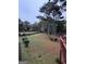 Expansive backyard with mature trees, a lush lawn, and a privacy fence at 105 Windridge Dr, Fayetteville, GA 30215