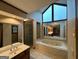 Bright bathroom featuring double vanity, soaking tub and glass enclosed shower at 105 Windridge Dr, Fayetteville, GA 30215