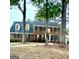 Charming two-story brick home with mature trees and well-maintained landscaping at 105 Windridge Dr, Fayetteville, GA 30215