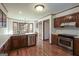 Well-lit kitchen featuring stainless steel appliances, wooden cabinets, and hardwood floors at 105 Windridge Dr, Fayetteville, GA 30215