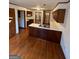 Well-lit kitchen featuring wood cabinets, a stainless steel sink, and sleek countertops atop hardwood floors at 105 Windridge Dr, Fayetteville, GA 30215