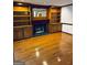 Living room with hardwood floors, a fireplace, and custom built-in shelving at 105 Windridge Dr, Fayetteville, GA 30215