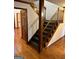 Carpeted staircase with wood trim and hardwood floors at 105 Windridge Dr, Fayetteville, GA 30215