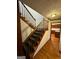 Wooden staircase with carpet runner, leading to the upper level and hardwood floors at 105 Windridge Dr, Fayetteville, GA 30215