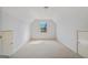 Spacious attic featuring dormer window and neutral carpeting at 1500 Royce Dr, Locust Grove, GA 30248