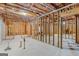 Unfinished basement featuring exposed framing offering a blank canvas for customization and future expansion at 1500 Royce Dr, Locust Grove, GA 30248