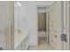 Well-lit bathroom featuring a vanity with ample counter space and a doorway leading to the bath/shower area at 1500 Royce Dr, Locust Grove, GA 30248