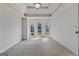 Empty bedroom boasts a tray ceiling, recessed lights, three windows, and neutral carpet at 1500 Royce Dr, Locust Grove, GA 30248