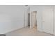 Bedroom features neutral carpet, a white wall, and three doors at 1500 Royce Dr, Locust Grove, GA 30248