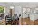 Cozy dining area with dark wood chairs and table, seamlessly connected to the kitchen and staircase at 1500 Royce Dr, Locust Grove, GA 30248