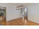 Elegant dining room with hardwood floors, modern lighting fixture, and classic wainscoting at 1500 Royce Dr, Locust Grove, GA 30248